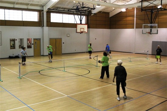 People playing Kickball on the Pickle Ball Courts
