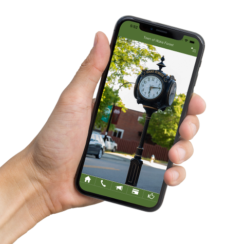 Cell phone in hand with the Town of Wake Forest Logo on the screen